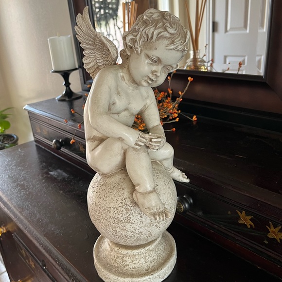 Resin angel statue on a ball 14 1/2 tall 8” wide cream colored